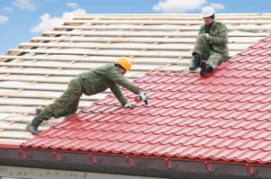  workers on roof with metal tile and roofing iron