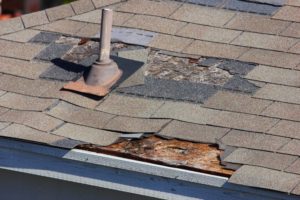 shingles being blown off a roof and other roof damage reqiring roof repair or replacement